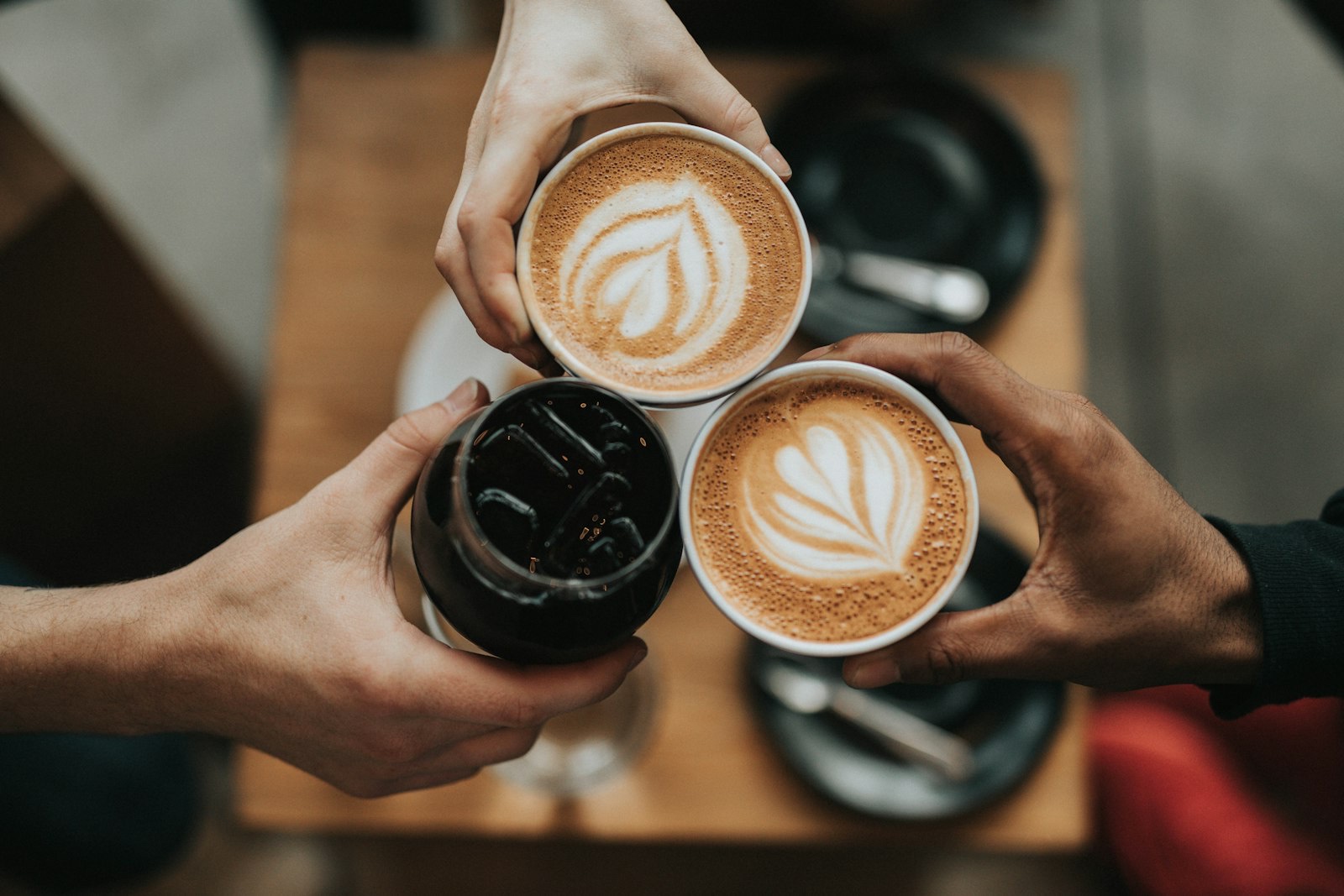 Hands meeting over coffee